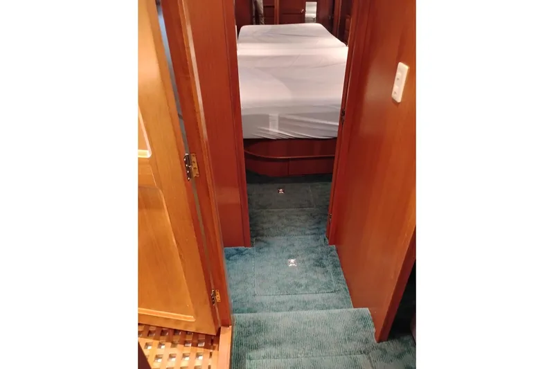 Slide: The Image of Interior of 1997 Symbol 50 Pilothouse yacht with carpeted stairs and wooden doors. - 62