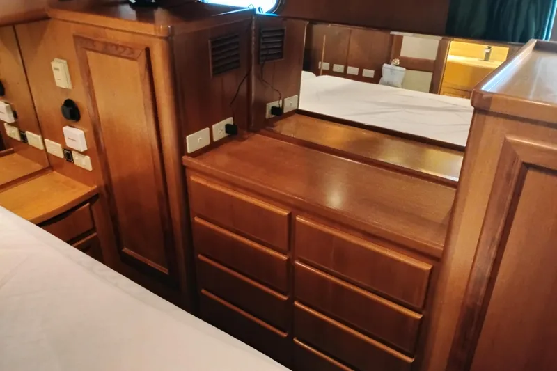 Slide: The Image of Wooden interior of a 1997 Symbol 50 Pilothouse yacht with drawers and electrical outlets. - 65