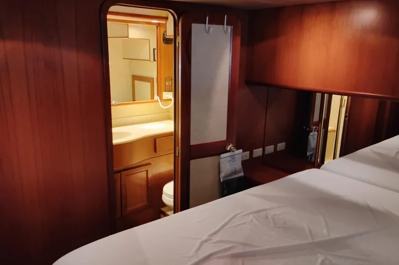 Slide: The Image of Interior of 1997 Symbol 50 Pilothouse yacht with wooden paneling and bathroom view. - 66
