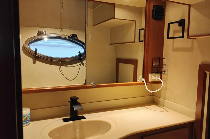 Slide: The Image of Bathroom interior of a 1997 Symbol 50 Pilothouse yacht with oval porthole window. - 67