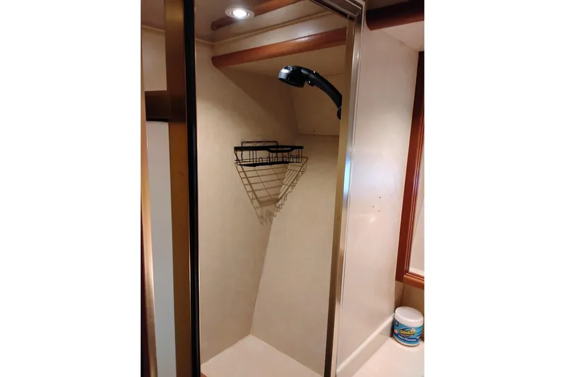 Slide: The Image of Shower area in a 1997 Symbol 50 Pilothouse yacht with a wall-mounted basket. - 68
