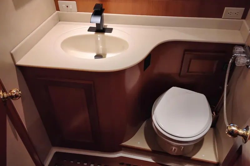 Slide: The Image of Bathroom interior of a 1997 Symbol 50 Pilothouse yacht, featuring sink and toilet. - 78