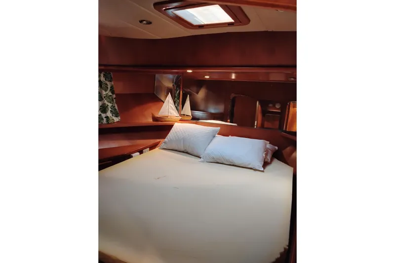 Slide: The Image of Cozy cabin interior of 1997 Symbol 50 Pilothouse yacht with bed and decorative sailboat. - 81