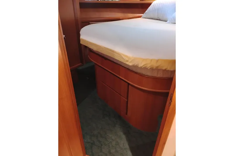Slide: The Image of Cozy bedroom interior of 1997 Symbol 50 Pilothouse yacht with wooden cabinetry. - 84