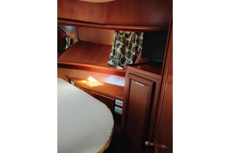 Slide: The Image of Cozy cabin interior of 1997 Symbol 50 Pilothouse with wood finish and tropical curtains. - 85