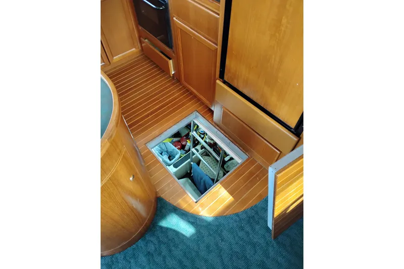Slide: The Image of Wooden interior of a 1997 Symbol 50 Pilothouse yacht with open floor storage. - 87