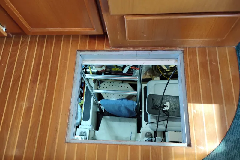 Slide: The Image of Engine compartment access on 1997 Symbol 50 Pilothouse boat with wooden flooring. - 88