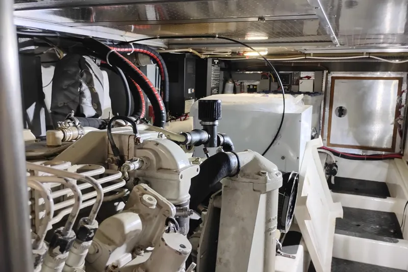 Slide: The Image of Engine room of a 1997 Symbol 50 Pilothouse yacht, showcasing mechanical components. - 89