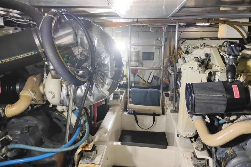 Slide: The Image of Engine room of a 1997 Symbol 50 Pilothouse yacht, showcasing mechanical components and equipment. - 93