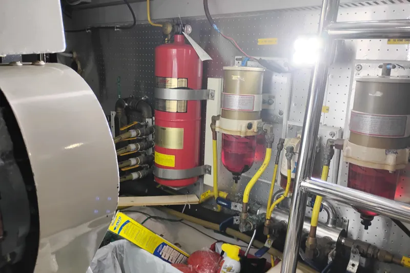 Slide: The Image of Engine room of a 1997 Symbol 50 Pilothouse with fire extinguisher and fuel filters. - 96