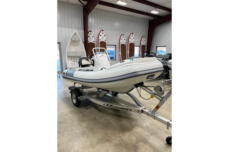 The Image of 2026 Highfield Sport 330 boat on trailer in showroom. - 0