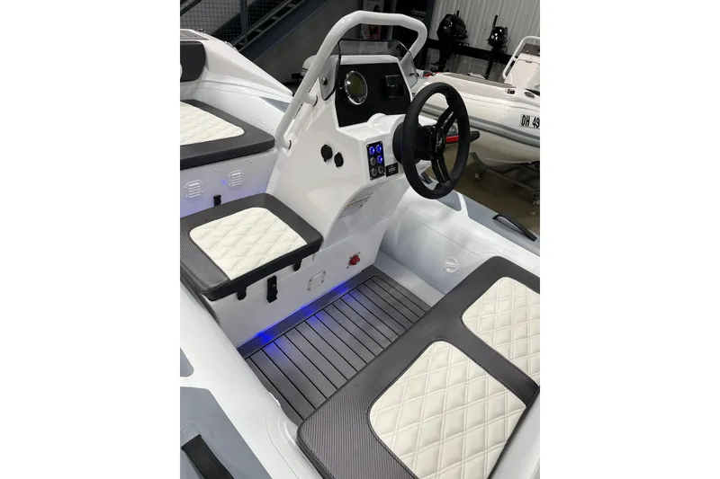 Slide: The Image of 2026 Highfield Sport 330 boat interior with modern dashboard and quilted seating. - 5