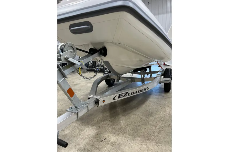 Slide: The Image of 2026 Highfield Sport 330 boat on EZ Loader trailer in a garage. - 8