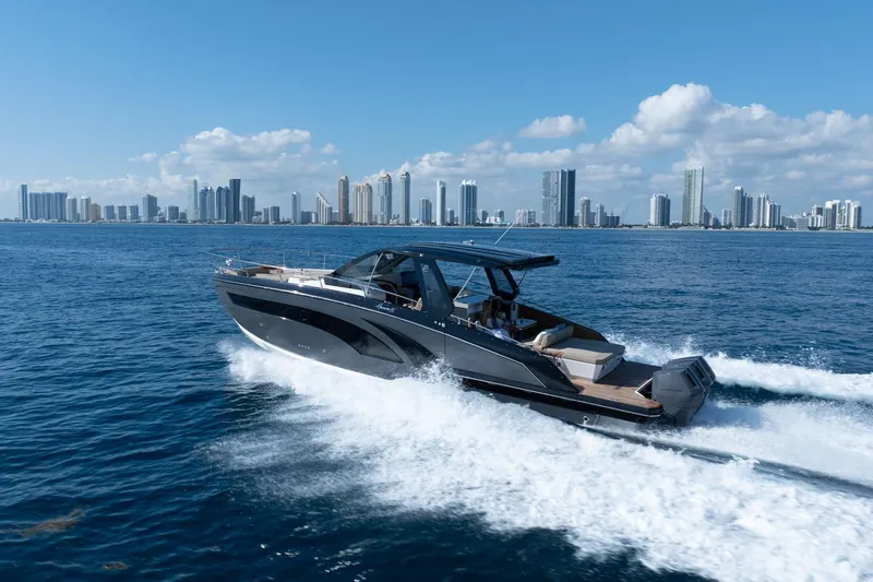 The Image of 2026 Hanover 447 yacht cruising near city skyline under clear blue sky. - 1