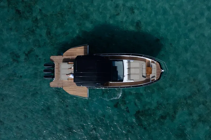 Slide: The Image of Aerial view of Hanover 447 yacht, 2026 model, on clear turquoise water. - 21