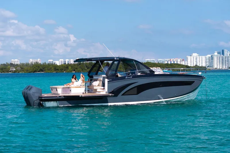 Slide: The Image of Luxurious 2026 Hanover 447 yacht cruising on turquoise waters near a city skyline. - 22