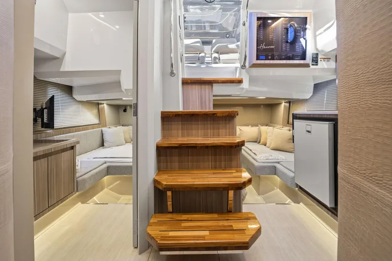 Slide: The Image of Luxurious interior of 2026 Hanover 447 yacht with wooden stairs and cozy seating area. - 59