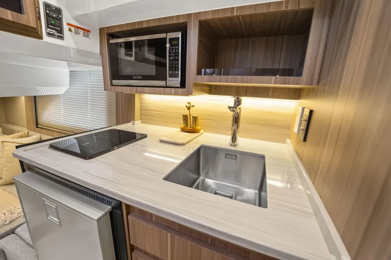 Slide: The Image of Modern RV kitchen interior with sleek appliances, Hanover 447 model, 2026. - 60