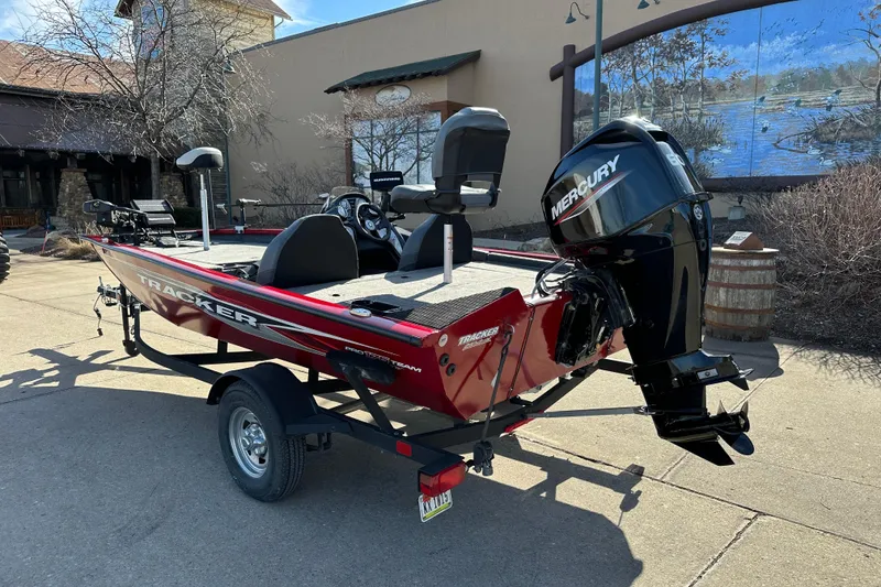 Slide: The Image of 2024 Tracker Pro Team 175 TXW boat with Mercury engine, parked outdoors. - 2