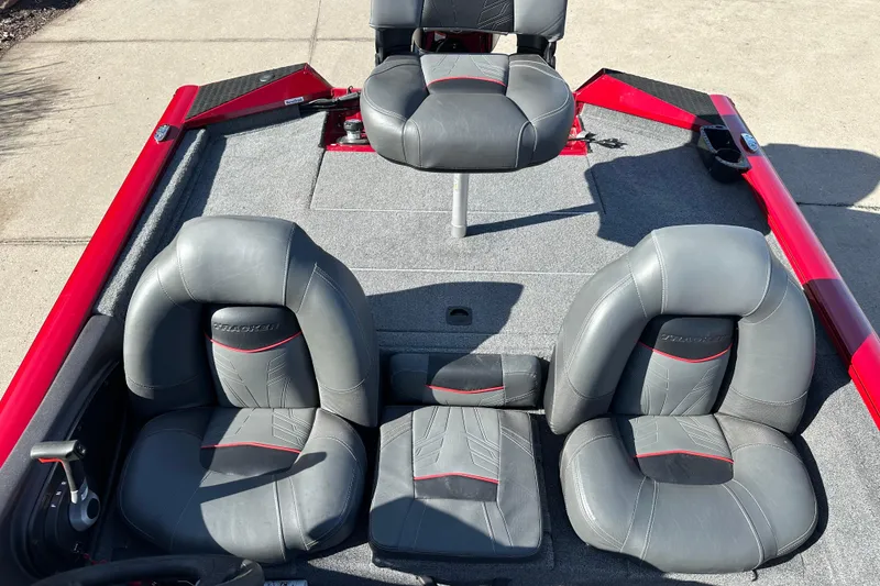 Slide: The Image of 2024 Tracker Pro Team 175 TXW boat interior with gray and red seating. - 8