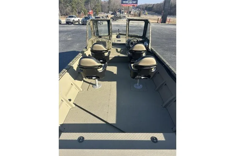 Slide: The Image of 2026 SeaArk 2272 MV boat interior with four seats, open deck, and windshield. - 4