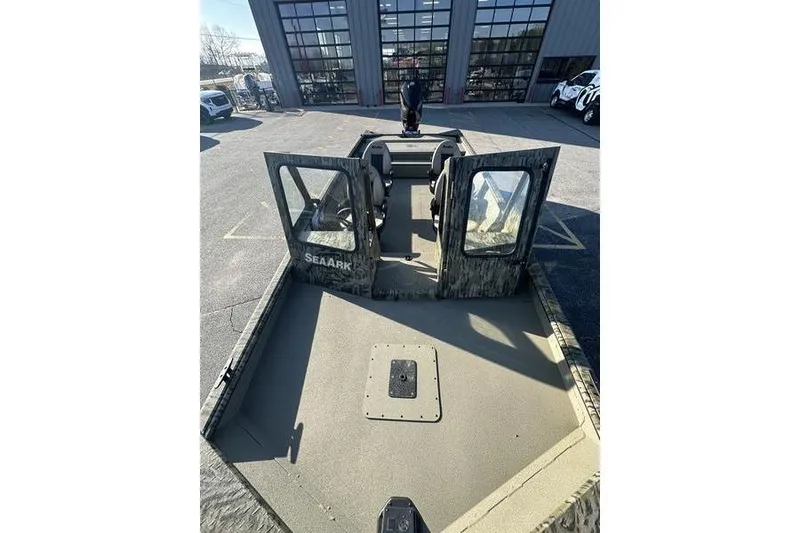 Slide: The Image of 2026 SeaArk 2272 MV boat with open doors, parked outdoors. - 6