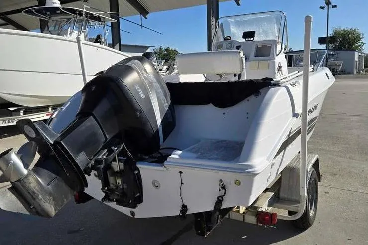 Slide: The Image of 2001 Pro-Line 19 Sport boat with outboard motor on trailer in a marina. - 10