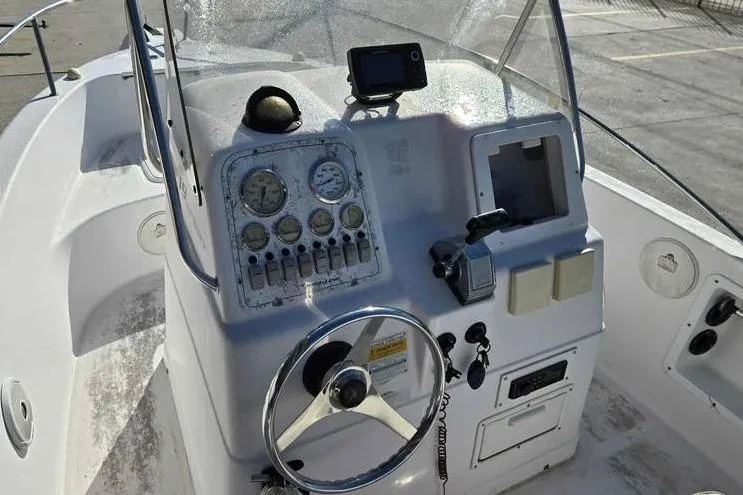 Slide: The Image of 2001 Pro-Line 19 Sport boat dashboard with steering wheel and navigation instruments. - 4