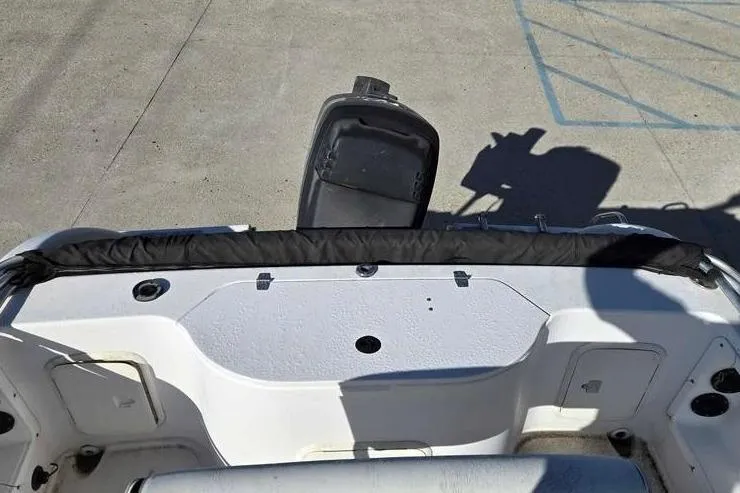 Slide: The Image of 2001 Pro-Line 19 Sport boat interior with open storage compartment and motor. - 5