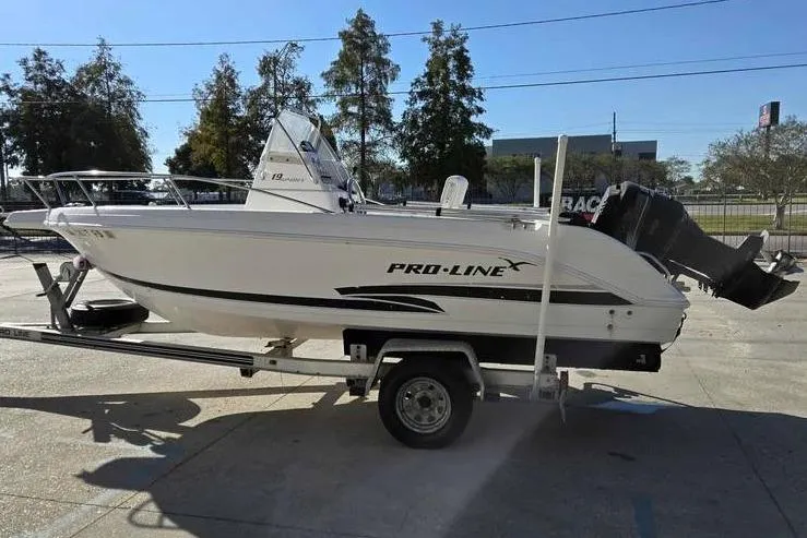 Slide: The Image of 2001 Pro-Line 19 Sport boat on trailer, parked outdoors in sunny setting. - 6
