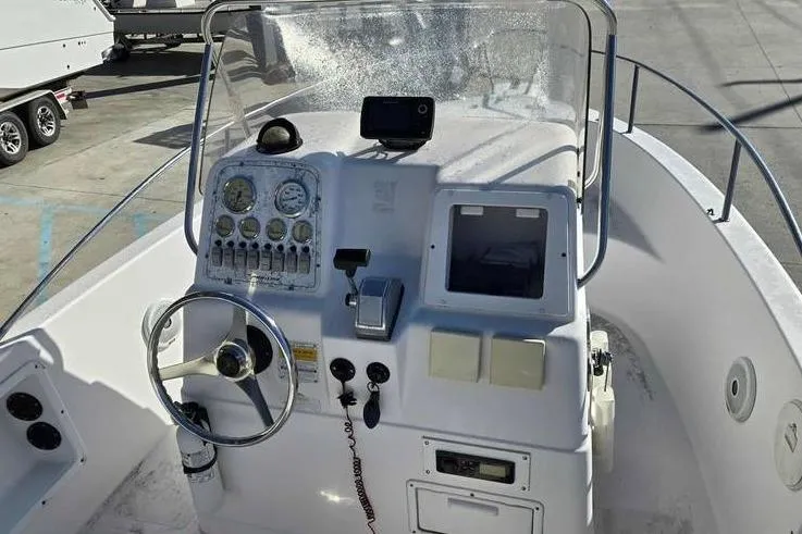 Slide: The Image of 2001 Pro-Line 19 Sport boat dashboard with steering wheel and control panel. - 7