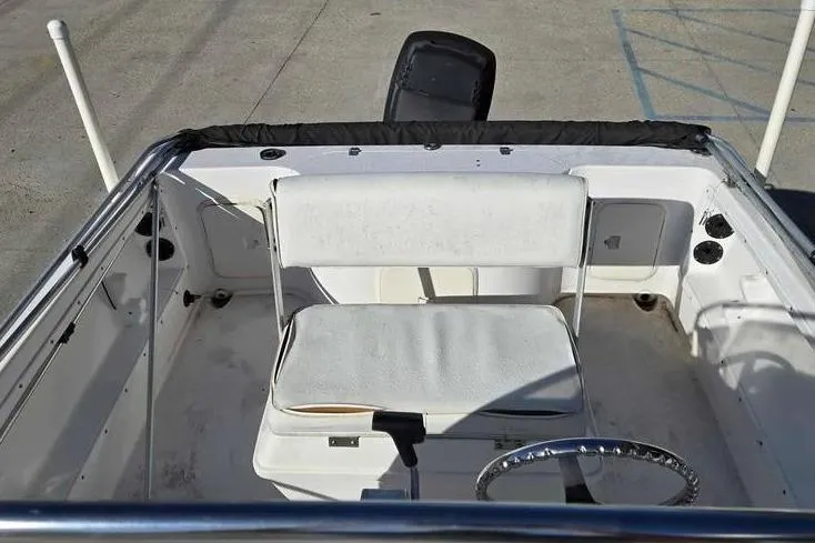 Slide: The Image of 2001 Pro-Line 19 Sport boat interior with white seating and steering wheel. - 8