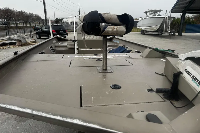 Slide: The Image of 2007 SeaArk Coastal 200 CC boat with Minn Kota trolling motor, parked outdoors. - 11