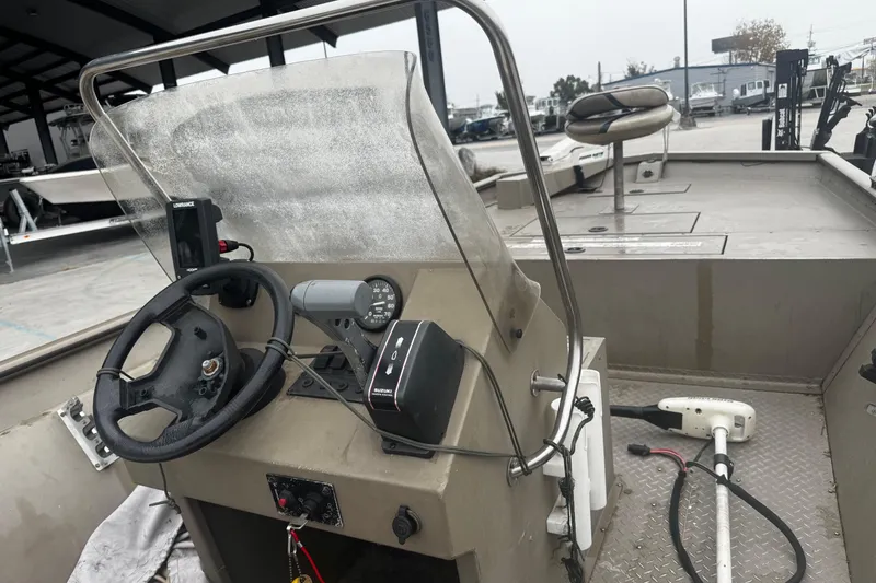 Slide: The Image of 2007 SeaArk Coastal 200 CC boat interior with steering console and seating. - 8