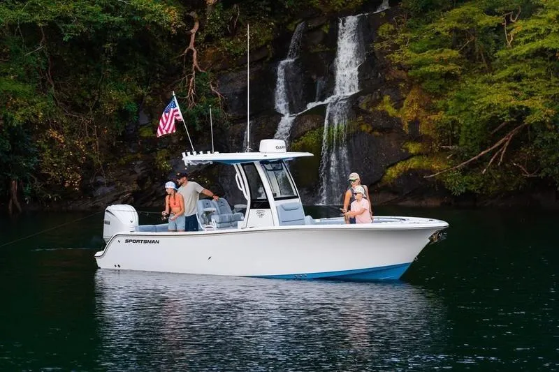The Image of 2026 Sportsman Heritage 231 Center Console boat near waterfall, surrounded by lush greenery. - 0