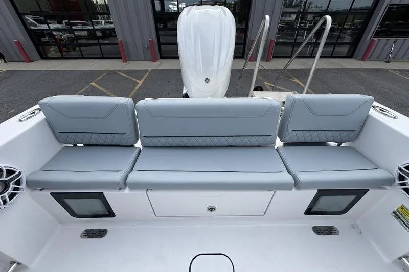Slide: The Image of 2026 Sportsman Heritage 231 Center Console boat with gray seating and storage compartments. - 11