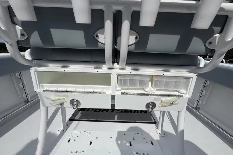 Slide: The Image of 2026 Sportsman Heritage 231 Center Console boat interior with storage compartments and seating. - 12
