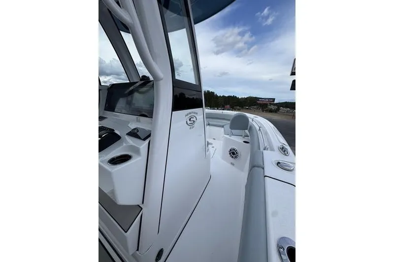 Slide: The Image of 2026 Sportsman Heritage 231 Center Console boat, sleek design, spacious deck, modern features. - 14