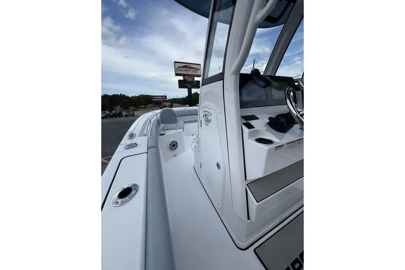 Slide: The Image of 2026 Sportsman Heritage 231 Center Console boat interior with steering console and seating. - 15