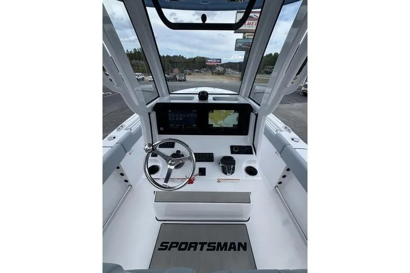 Slide: The Image of 2026 Sportsman Heritage 231 Center Console boat interior with steering wheel and navigation display. - 16