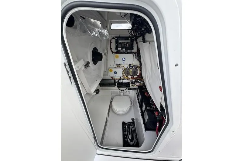 Slide: The Image of 2026 Sportsman Heritage 231 Center Console interior with wiring and equipment. - 18