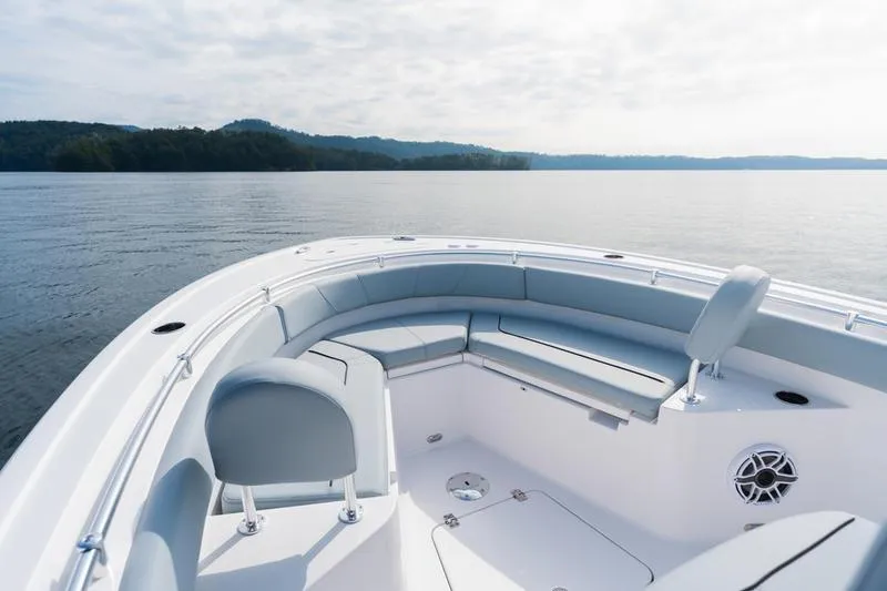 Slide: The Image of 2026 Sportsman Heritage 231 Center Console boat on calm lake waters. - 23