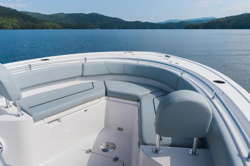 Slide: The Image of 2026 Sportsman Heritage 231 Center Console boat on a serene lake with scenic mountain backdrop. - 25