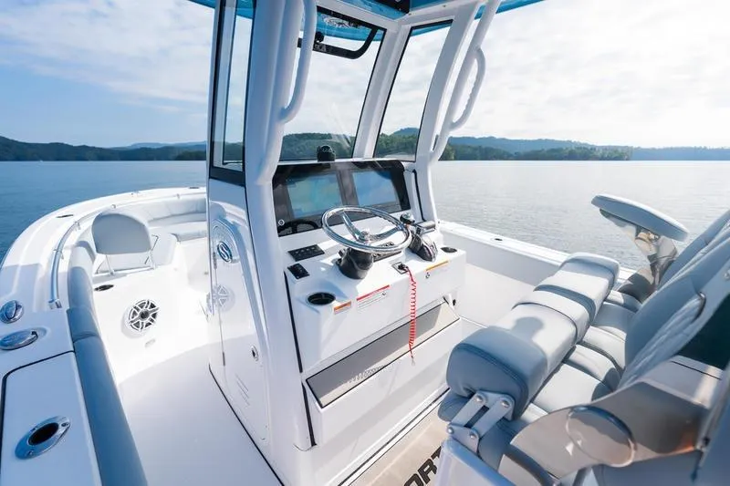 Slide: The Image of 2026 Sportsman Heritage 231 Center Console boat interior on a serene lake. - 28