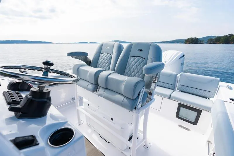 Slide: The Image of 2026 Sportsman Heritage 231 Center Console boat interior with luxurious seating and steering wheel. - 37