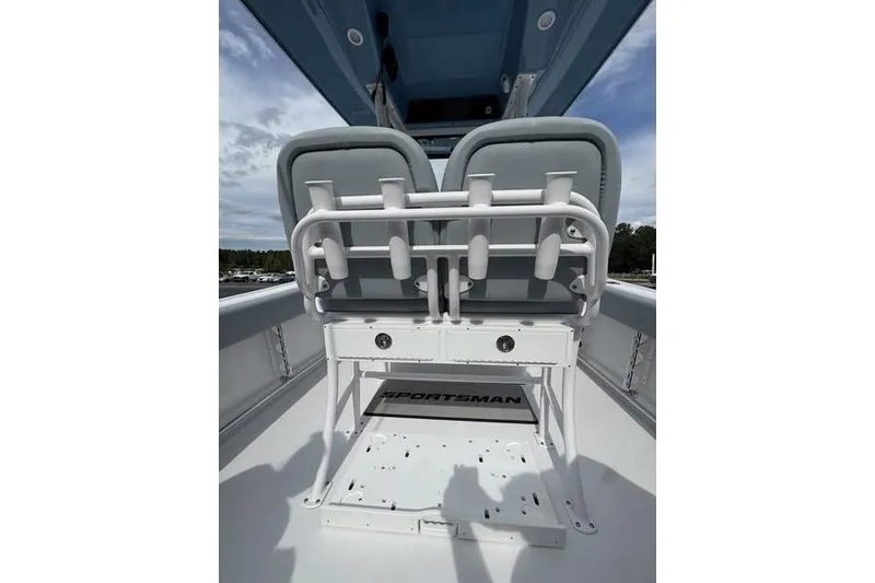 Slide: The Image of 2026 Sportsman Heritage 231 Center Console boat interior with dual seats and rod holders. - 9