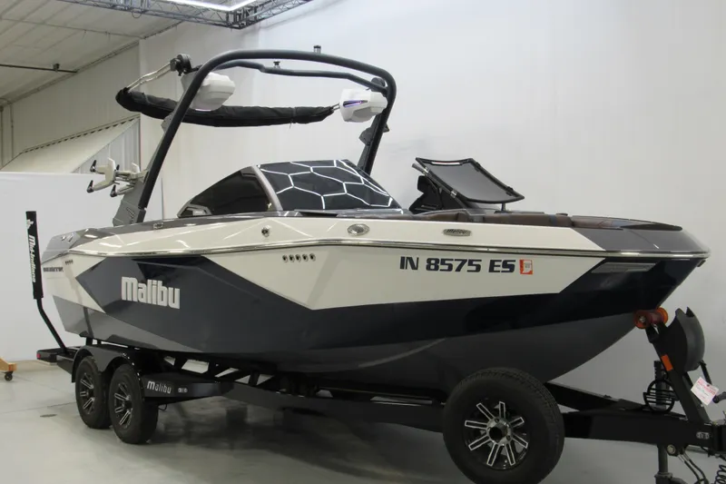 Slide: The Image of 2025 Malibu Wakesetter 23 LSV boat on trailer in indoor showroom. - 1