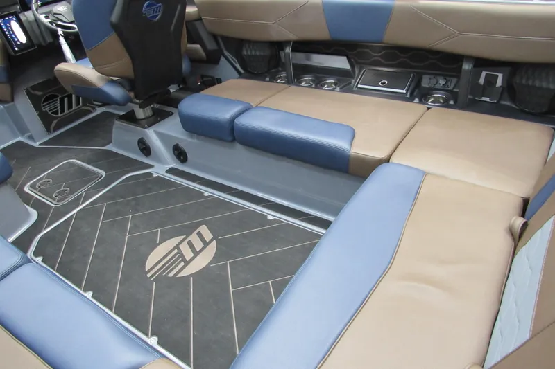 Slide: The Image of 2025 Malibu Wakesetter 23 LSV interior with blue and brown seating, modern design. - 16