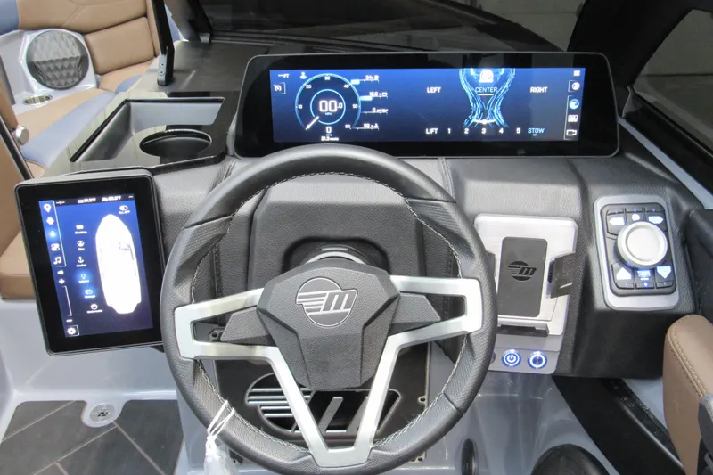 Slide: The Image of 2025 Malibu Wakesetter 23 LSV dashboard with advanced digital controls and steering wheel. - 19