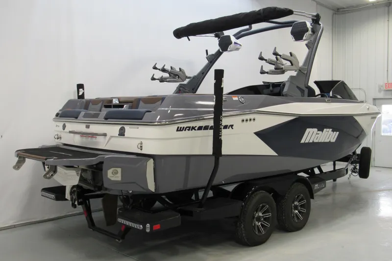 Slide: The Image of 2025 Malibu Wakesetter 23 LSV boat in showroom, featuring sleek design and advanced wakeboarding features. - 3